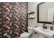 Charming powder room featuring unique floral wallpaper and a pedestal sink at 440 Pierce Landing Dr, Garner, NC 27529