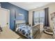 bedroom featuring a fun blue wall, a bed, and Star Wars light sabers at 440 Pierce Landing Dr, Garner, NC 27529