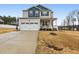 Charming two-story home with a welcoming front porch and a well-manicured lawn at 440 Pierce Landing Dr, Garner, NC 27529