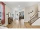 Inviting foyer with hardwood floors, staircase, and view into the living room, flooded with natural light at 440 Pierce Landing Dr, Garner, NC 27529