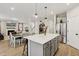 View of kitchen island into the living space with open floor plan and stainless steel appliances at 440 Pierce Landing Dr, Garner, NC 27529