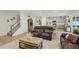 Open-concept living room with wood floors and view of the modern kitchen at 440 Pierce Landing Dr, Garner, NC 27529