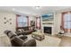 Cozy living room features a fireplace and large windows, creating a relaxing atmosphere at 440 Pierce Landing Dr, Garner, NC 27529