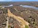 Aerial view showcases a residential area with a golf course, a large lake and homes surrounded by lush green trees at 4405 Turnberry Cir, Durham, NC 27712