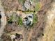 Aerial view of the estate, reveals a private pool, gray roof, mature trees, and well-maintained surrounding areas at 4405 Turnberry Cir, Durham, NC 27712