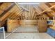 Unfinished attic features wood beams, storage and lighting at 4405 Turnberry Cir, Durham, NC 27712