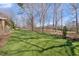 Expansive backyard with green grass and mature trees, creating a serene and private outdoor space at 4405 Turnberry Cir, Durham, NC 27712