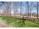 Large backyard with mature trees perfect for outdoor activities at 4405 Turnberry Cir, Durham, NC 27712