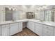 Modern bathroom with double vanity, white cabinets, and a large mirror at 4405 Turnberry Cir, Durham, NC 27712