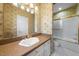 Bathroom featuring unique wallpaper, vanity and shower with gold accents at 4405 Turnberry Cir, Durham, NC 27712