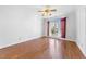 Spacious bedroom with hardwood floors, ceiling fan, and large windows at 4405 Turnberry Cir, Durham, NC 27712