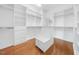 Large walk-in closet with custom shelving, drawers, and bench seating at 4405 Turnberry Cir, Durham, NC 27712