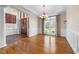 Dining room with hardwood floors, wainscoting, and ample natural light from the large window at 4405 Turnberry Cir, Durham, NC 27712