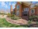 Welcoming brick home entrance with a curved brick path leading to elegant double doors and blooming flowers at 4405 Turnberry Cir, Durham, NC 27712
