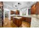 An inviting kitchen boasts an island, stainless appliances, and a sunlit breakfast nook at 4405 Turnberry Cir, Durham, NC 27712