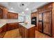 A spacious kitchen features custom wood cabinets, granite countertops, and a central island at 4405 Turnberry Cir, Durham, NC 27712