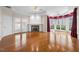A cozy living room features a fireplace, hardwood floors, and french doors at 4405 Turnberry Cir, Durham, NC 27712