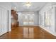 Bright sunroom with hardwood floors, large windows, and intricate crown molding at 4405 Turnberry Cir, Durham, NC 27712