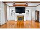 Bright living room with hardwood flooring, fireplace, and built-in shelving at 4405 Turnberry Cir, Durham, NC 27712