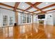 Open-concept living room with a fireplace, hardwood floors, and access to the outdoor space at 4405 Turnberry Cir, Durham, NC 27712