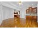Spacious living room with hardwood floors, detailed crown molding, and glass door cabinets at 4405 Turnberry Cir, Durham, NC 27712