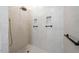 An elegant shower featuring custom tile, built-in shelves, and modern fixtures at 4405 Turnberry Cir, Durham, NC 27712