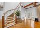 Elegant curved staircase with carpeted steps and wooden railing at 4405 Turnberry Cir, Durham, NC 27712