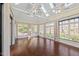Light-filled sunroom boasts multiple windows, skylights, and ceiling fans at 4405 Turnberry Cir, Durham, NC 27712