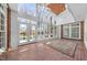 Bright sunroom with brick floors, many windows, and views of the backyard pool at 4405 Turnberry Cir, Durham, NC 27712