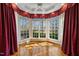 Sunroom featuring hardwood floors, large windows, and custom curtains at 4405 Turnberry Cir, Durham, NC 27712