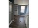 This bathroom features vinyl floors, a walk-in shower, window, and a sink with cabinet at 4600 Strawbush Rd, Spring Hope, NC 27882