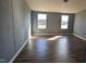 Spacious room featuring wood floors, neutral walls, and natural light at 4600 Strawbush Rd, Spring Hope, NC 27882
