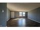 Large, empty living room with wood floors, neutral walls, and ample natural light at 4600 Strawbush Rd, Spring Hope, NC 27882