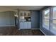Open-concept living space with a bar area, fireplace, and wood-look flooring at 4600 Strawbush Rd, Spring Hope, NC 27882