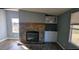 Cozy living room featuring a stone fireplace, built-in cabinets, and warm, wood-look flooring at 4600 Strawbush Rd, Spring Hope, NC 27882