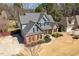 Aerial view of home, highlighting the well-manicured lawn, mature trees, and a large driveway at 4773 Swordfish Dr, Raleigh, NC 27603