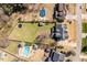 Expansive backyard featuring mature trees, an in-ground pool with lounge area, fully fenced yard and room to play at 4773 Swordfish Dr, Raleigh, NC 27603
