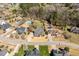 Overview of neighborhood showcasing lush landscaping, mature trees, inviting in-ground pool, and beautiful homes at 4773 Swordfish Dr, Raleigh, NC 27603