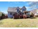 Backyard with a wooden deck, screened porch, and grassy area at 4773 Swordfish Dr, Raleigh, NC 27603