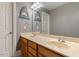Bathroom with a double sink vanity, neutral walls, decorative shark art and updated fixtures at 4773 Swordfish Dr, Raleigh, NC 27603