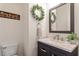 Charming half-bath with decorative wreath, marble countertop, and modern fixtures at 4773 Swordfish Dr, Raleigh, NC 27603