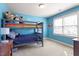 Blue bedroom featuring bunk beds and a large window at 4773 Swordfish Dr, Raleigh, NC 27603
