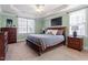 Spacious bedroom with a tray ceiling, neutral paint, and large windows offering plenty of natural light at 4773 Swordfish Dr, Raleigh, NC 27603