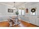 Charming dining area with hardwood floors, a modern light fixture, and a rustic wooden table with bench seating at 4773 Swordfish Dr, Raleigh, NC 27603