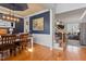 Elegant dining room with hardwood floors, blue accent wall, and views into living area at 4773 Swordfish Dr, Raleigh, NC 27603