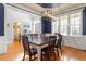 Elegant dining room with hardwood floors, blue accent wall, and natural light at 4773 Swordfish Dr, Raleigh, NC 27603
