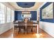 Elegant dining room with hardwood floors, blue accent wall, and modern chandelier at 4773 Swordfish Dr, Raleigh, NC 27603