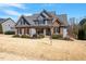 Charming two-story home featuring a combination of stone and blue siding under a roof at 4773 Swordfish Dr, Raleigh, NC 27603