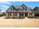 Charming two-story home featuring a combination of stone and blue siding under a roof at 4773 Swordfish Dr, Raleigh, NC 27603