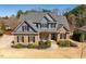 Charming two-story home featuring a combination of stone and blue siding under a roof at 4773 Swordfish Dr, Raleigh, NC 27603